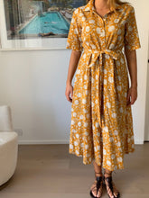 Load image into Gallery viewer, Created using the finest block printing techniques, the Georgia Dress in Golden Glow offers an elegant silhouette with a belted waist, mid length tailored sleeves and collared neckline to be worn open or buttoned all the way. She&#39;s flirtatious and fun, and very cool to wear when the temperature spikes. 
