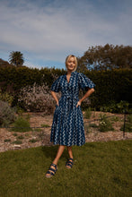 Load image into Gallery viewer, The Amelie dress offers a beautiful summer dress for all occasions. Lunches out or dinners in. She can be cinched in at the waist or left loose with a dropped waistline. Pockets and puffed sleeves… Yes, always and forever. Block printed by hand on 100% soft cotton.