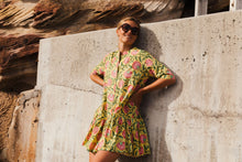 Load image into Gallery viewer, The Florence Drop Waist Dress in Illuminate print is a playful button-through mini dress with a drop waist, empire collar neckline and mid length tailored sleeves. 100% cotton. Block printed fabric. She&#39;s a bright ray of sunshine on a warm summers day. 