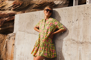 The Florence Drop Waist Dress in Illuminate print is a playful button-through mini dress with a drop waist, empire collar neckline and mid length tailored sleeves. 100% cotton. Block printed fabric. She's a bright ray of sunshine on a warm summers day. 